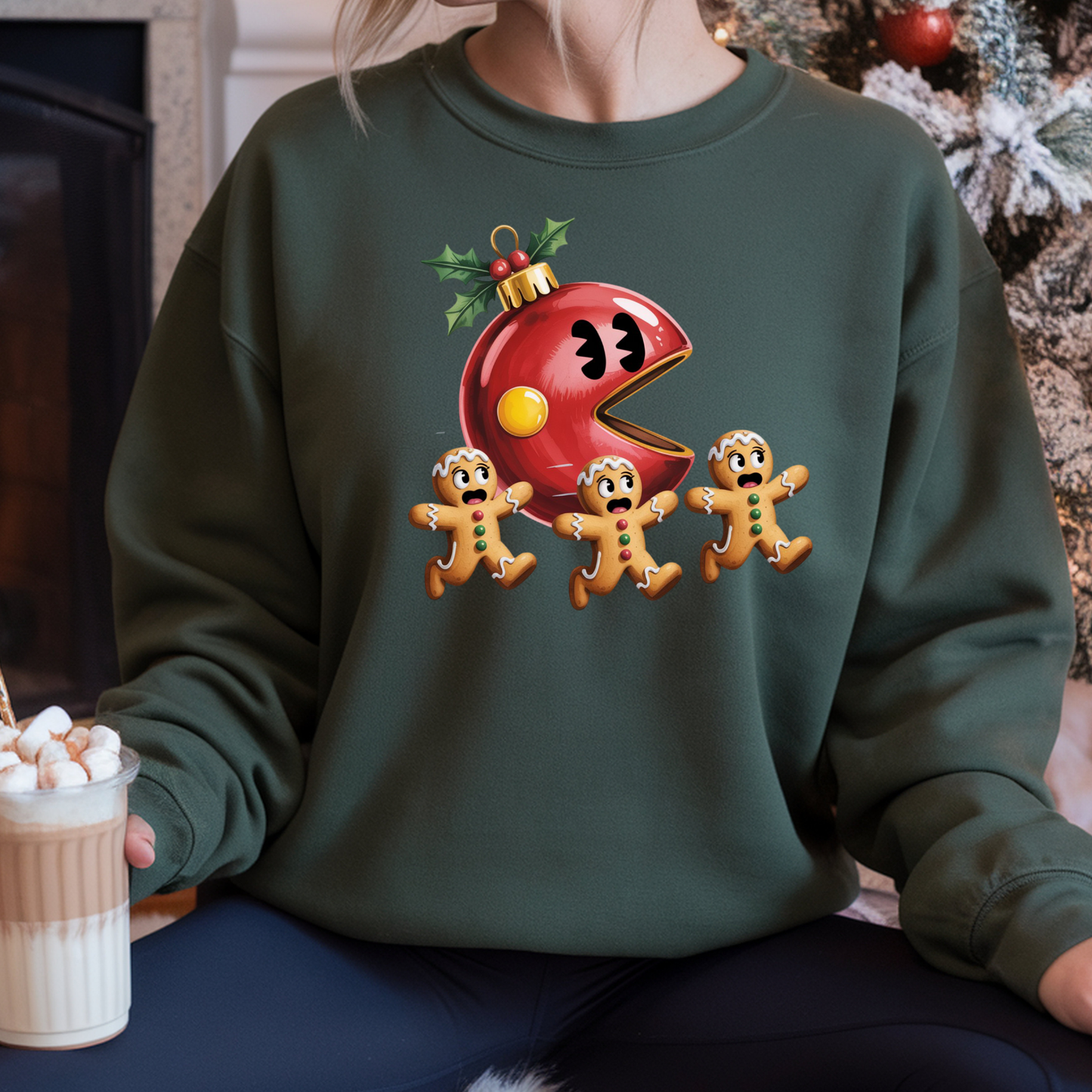 Person wearing a green sweatshirt with a Christmas-themed design featuring a red ornament and gingerbread men.