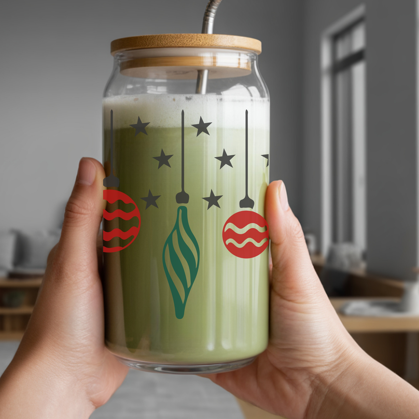 Glass jar with festive design held by a person indoors
