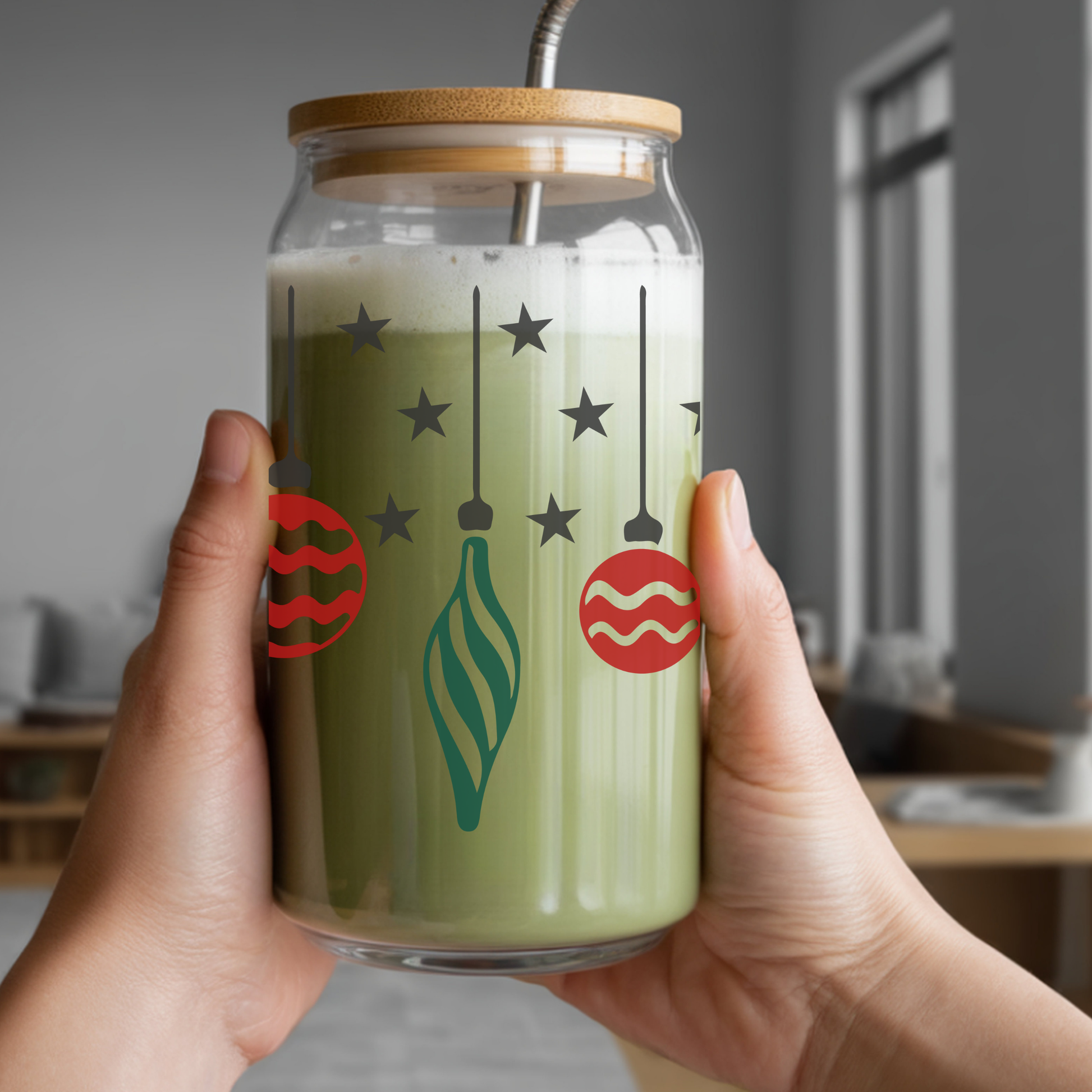Glass jar with festive design held by a person indoors