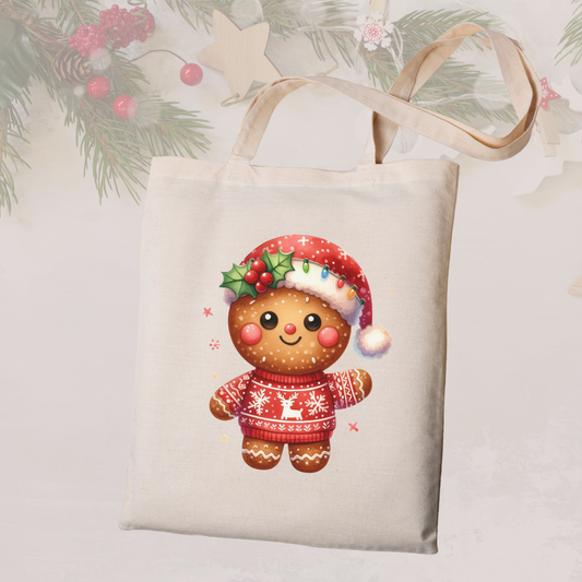 Tote bag with a Christmas-themed design of a gingerbread man wearing a sweater and hat, on a light background.