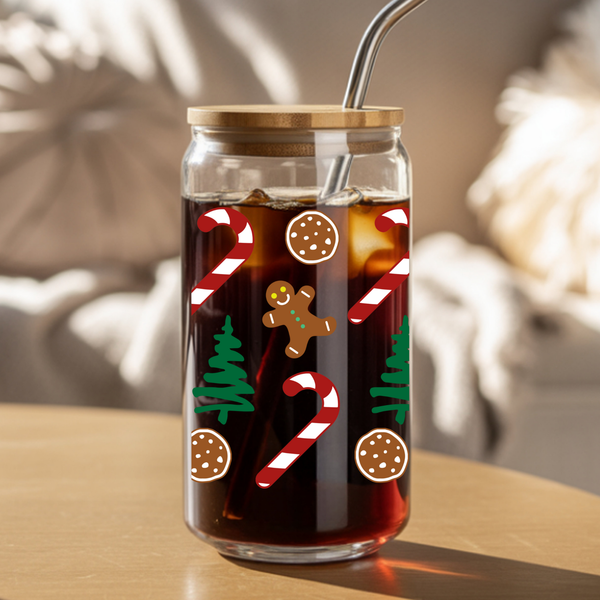 Glass tumbler with Christmas-themed design on a wooden table