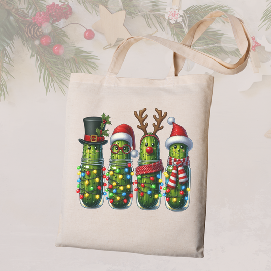 Tote bag with Christmas pickle design featuring lights and festive decorations on a light background.