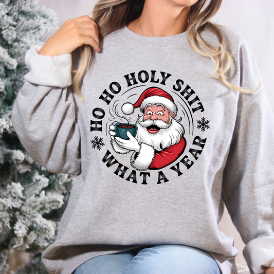 Person wearing a gray sweatshirt with a Christmas-themed graphic and text.