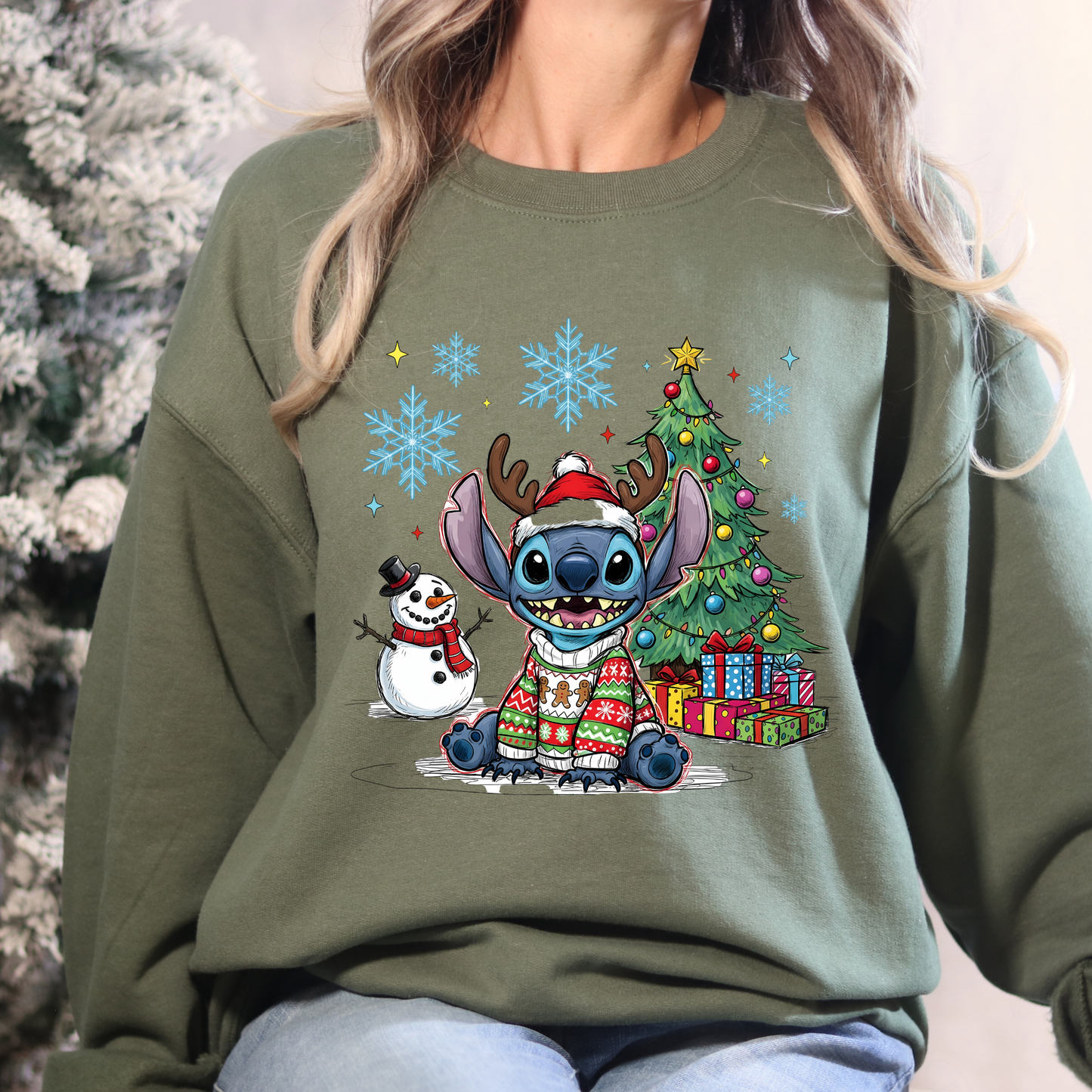 Person wearing a green sweatshirt with Christmas-themed design featuring Stitch and a snowman.