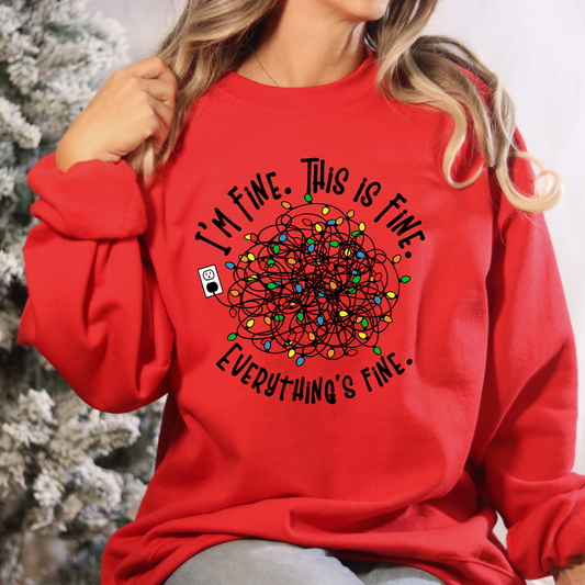 Red sweatshirt with a graphic design and text worn by a person against a blurred background