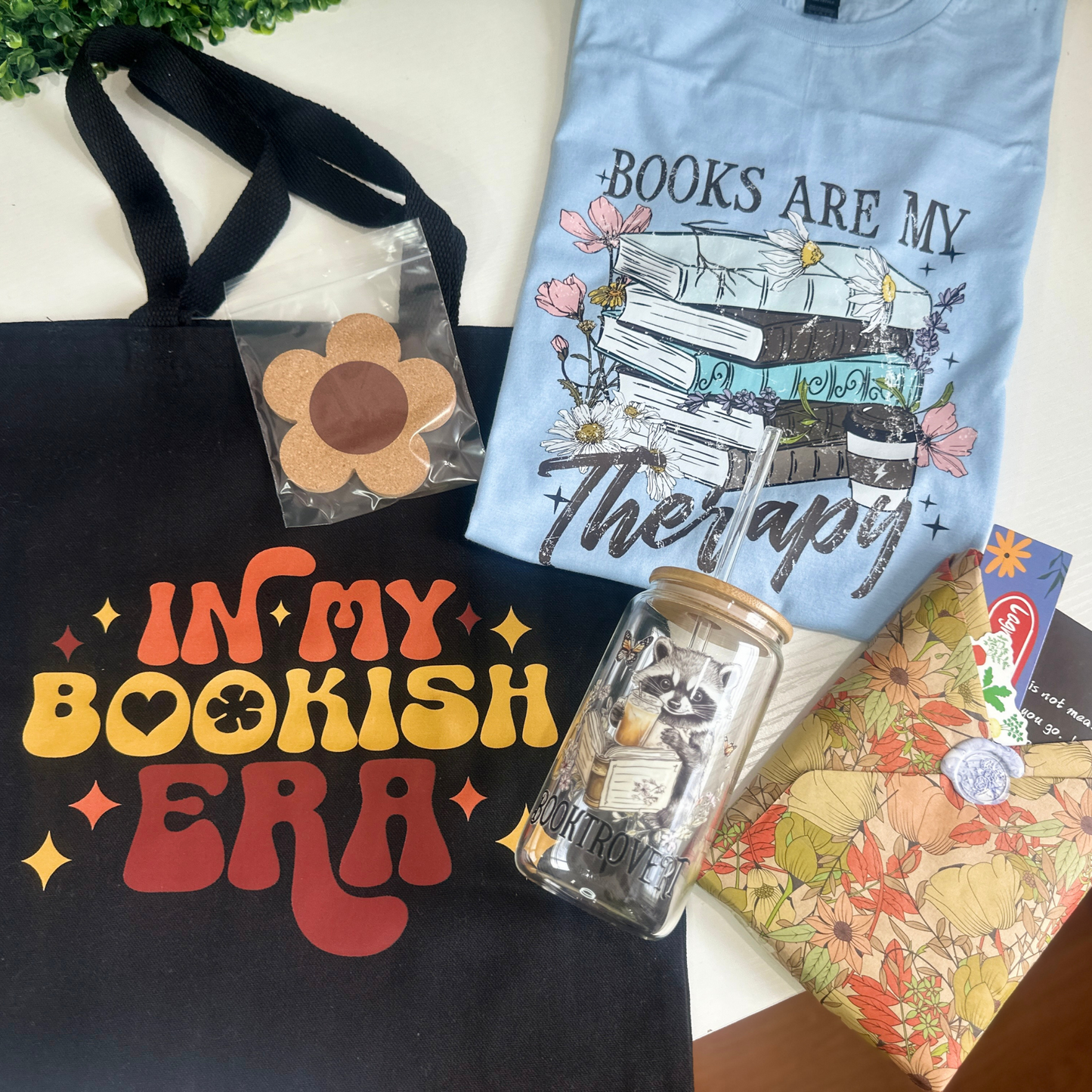 The Summer Bookish Bundle Includes:

-1 (one) Bookish T-Shirt&nbsp;

-1 Blind Book (you pick the genre!)

-1, 16oz Bookish Glass with lid and straw&nbsp;

- 1 Bookmark

-1 Coaster

-1 Tote Bag