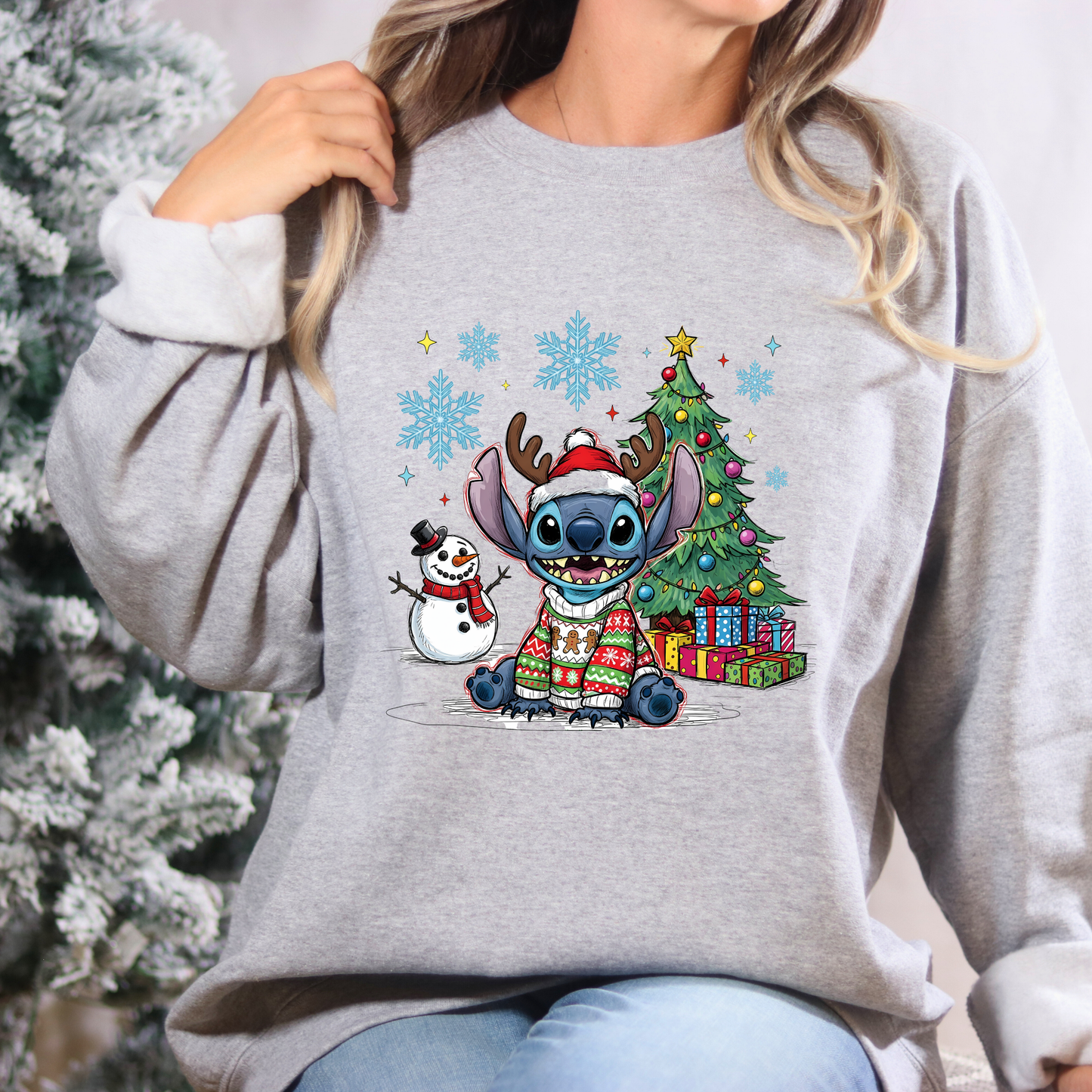Person wearing a gray sweatshirt with a Christmas-themed design featuring cartoon characters.