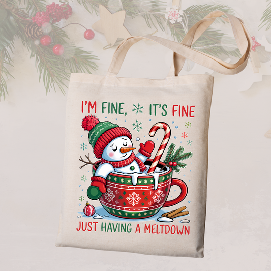 Tote bag with Christmas design featuring a snowman in a mug and text 'I'm fine, it's fine just having a meltdown' on a light background.
