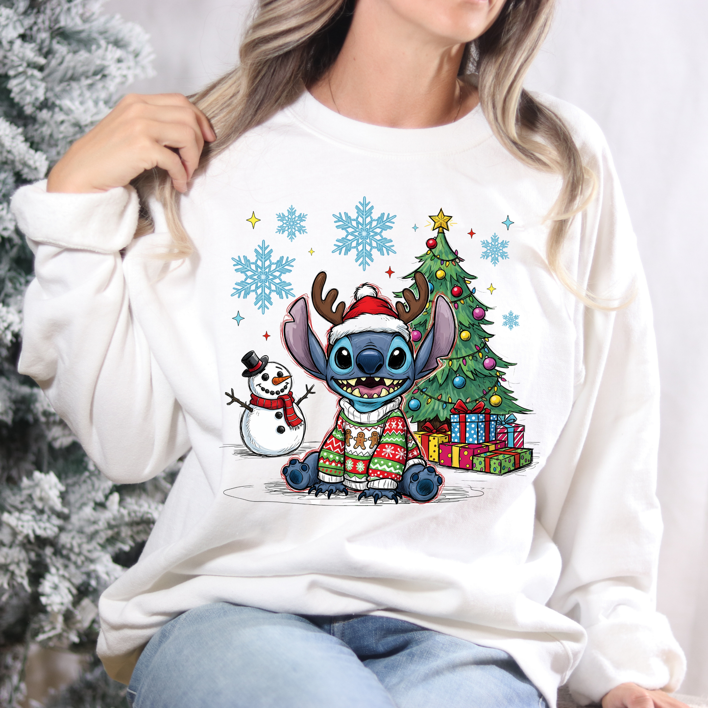 White sweatshirt with Christmas-themed design featuring cartoon characters, snowflakes, and a tree.